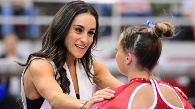 Arkansas gymnastics coach Jordyn Wieber talks things over during a meet at Barnhill Arena against Auburn.